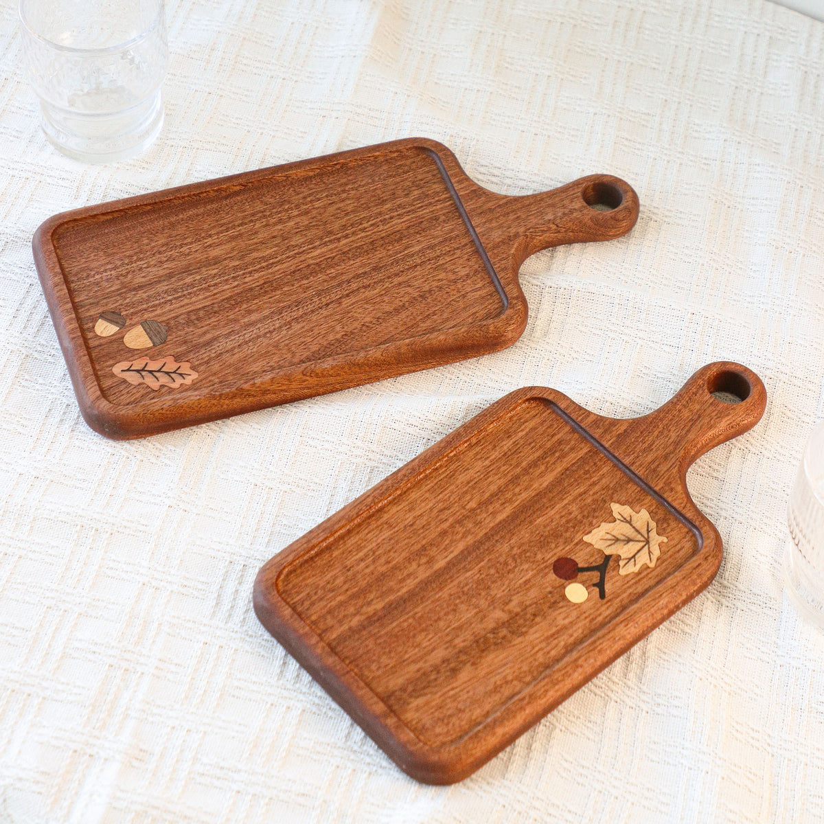 Two handled wooden serving boards with botanical inlay